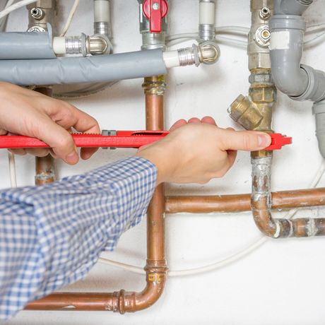 Man Repairing Pipes — Bloomington, MN — Richfield Plumbing Company