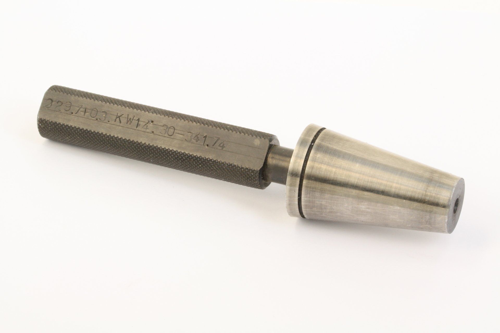Metal knurled hand tool with a silver conical attachment on a white background