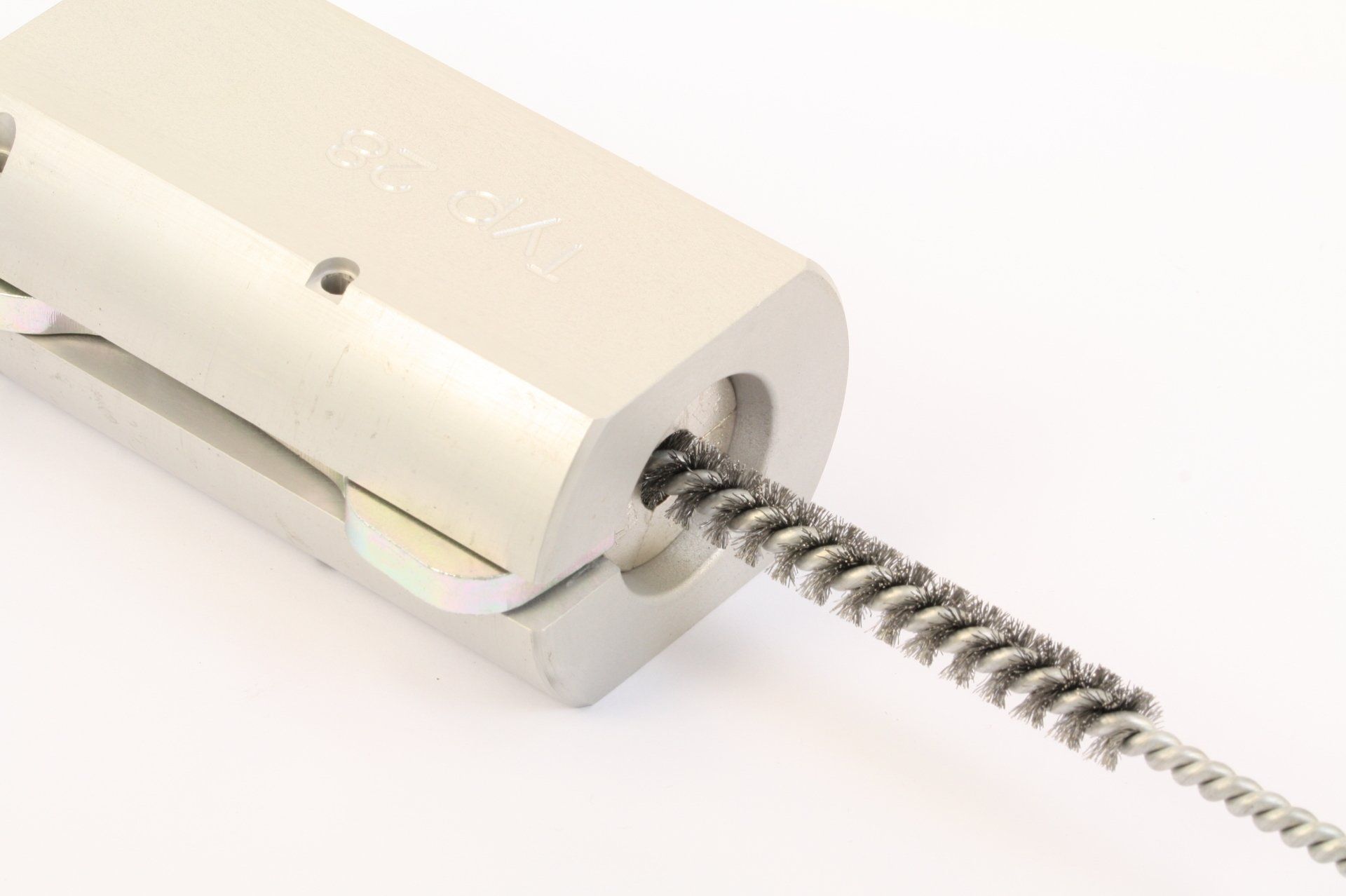A white plastic wall anchor with a metal screw partially inserted into it.