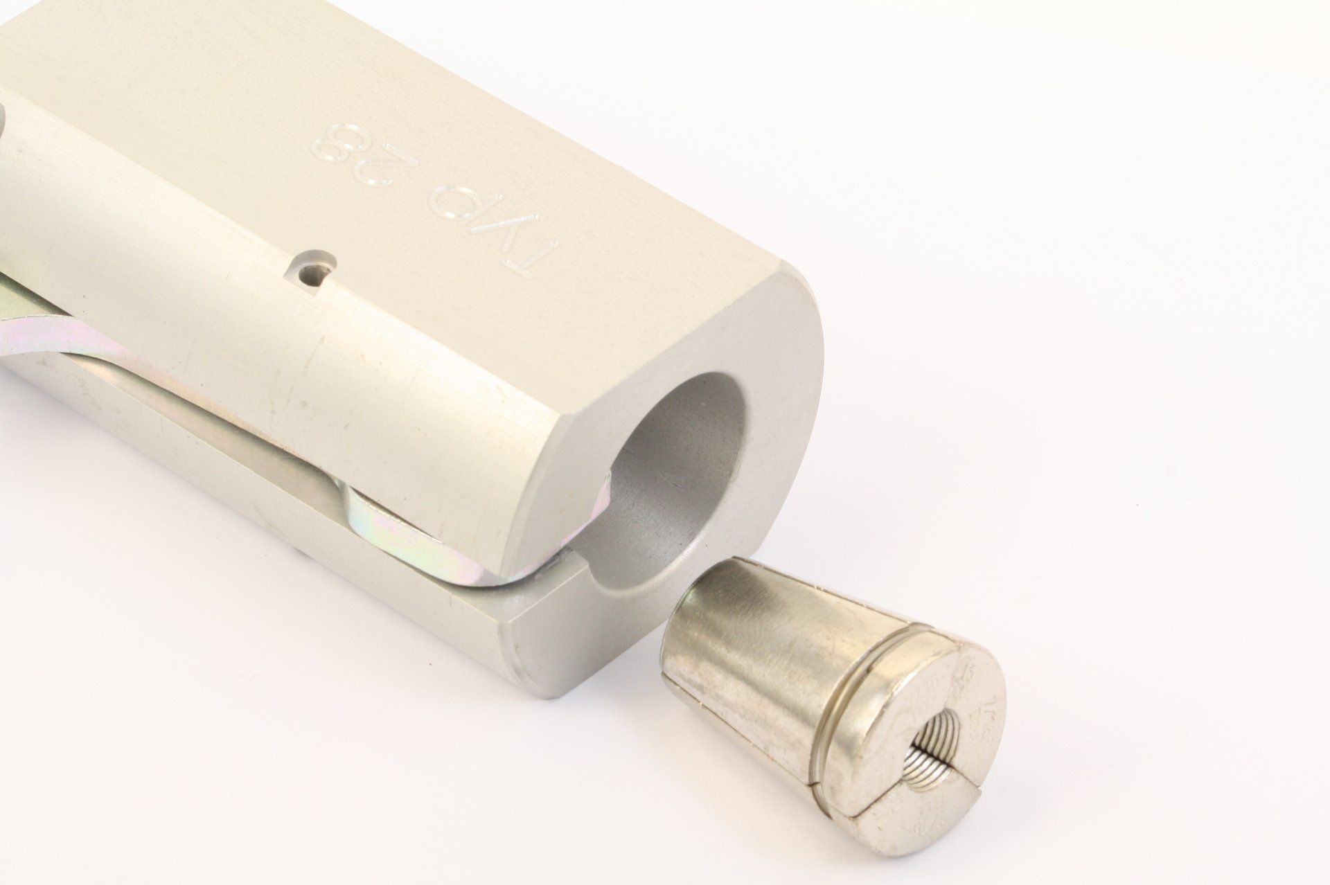 Close-up of a silver clamp mechanism with a cylindrical pin extending from the end