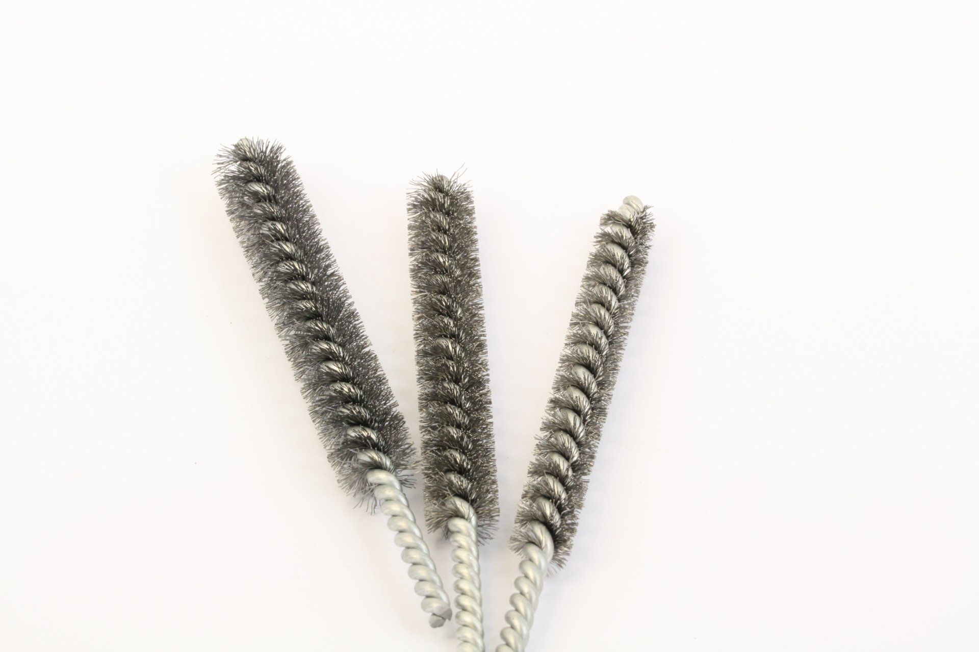 Three metal bottle brushes with silver bristles on a white background