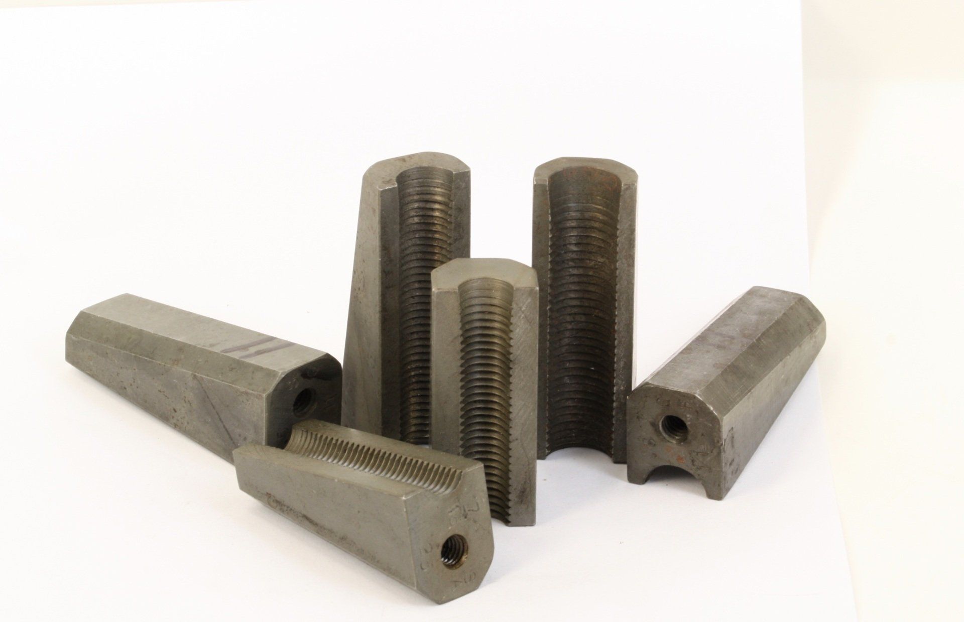 Metal threading dies and die holders on a white background