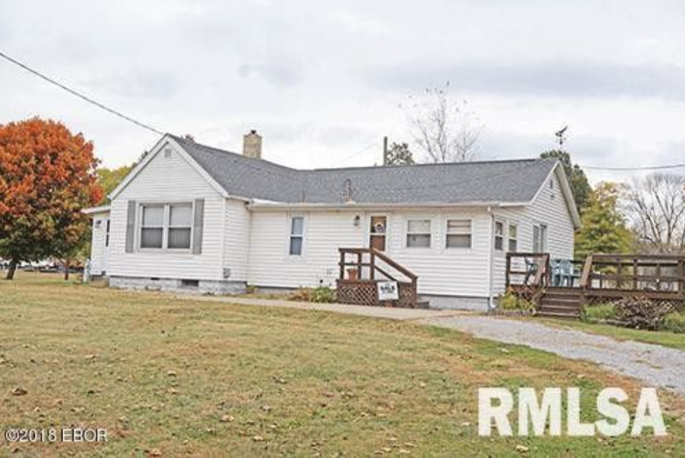 A white house with a gray roof is for sale in rmlsa
