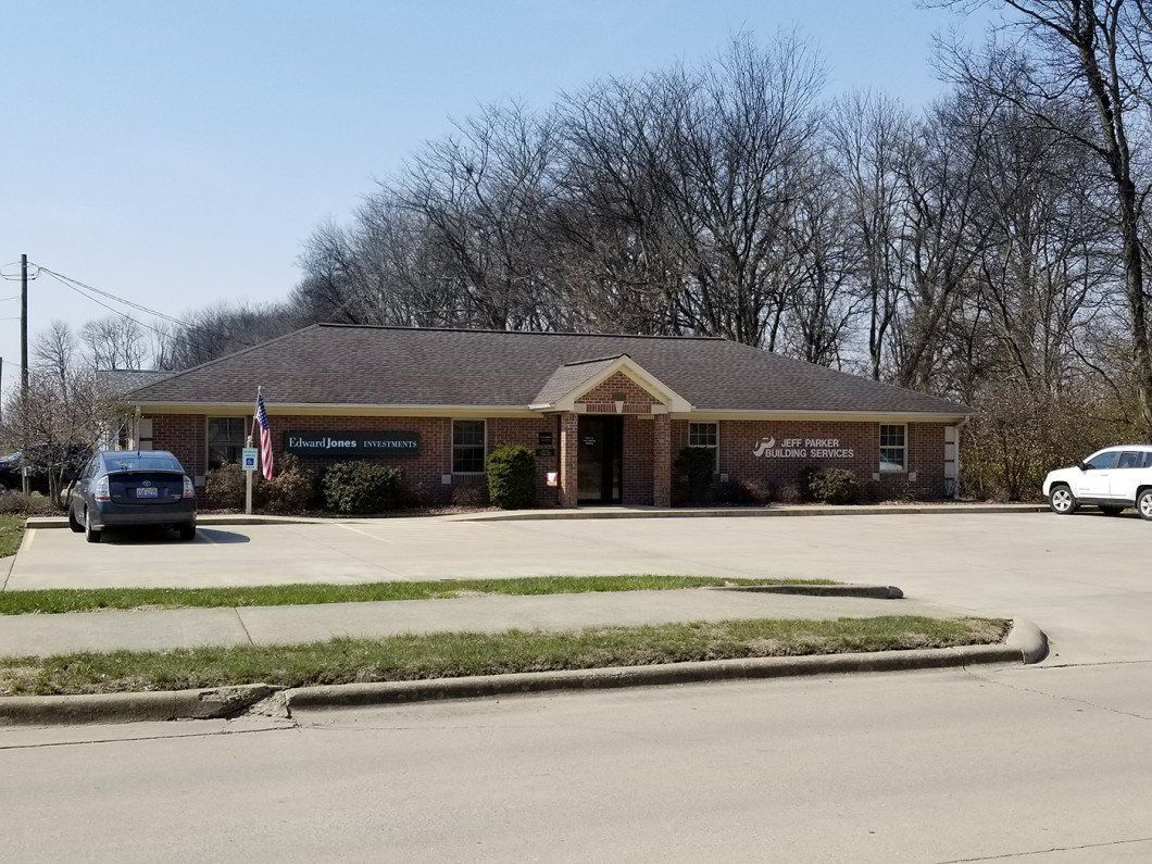 A brick building with a car parked in front of it.