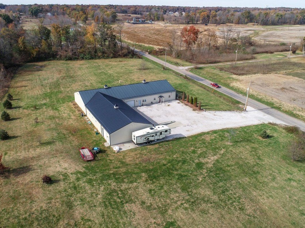 An aerial view of a large building in the middle of a field.