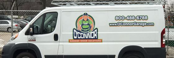 A white van with a logo on the side is parked in a parking lot.