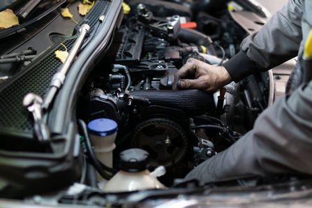 Man Working On Engine — East Longmeadow, MA — Hi-Tech Transmission Inc Man Working On Engine — East Longmeadow, MA — Hi-Tech Transmission Inc