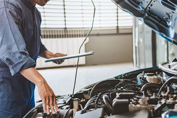 Man Checking On Engine — East Longmeadow, MA — Hi-Tech Transmission Inc Man Checking On Engine — East Longmeadow, MA — Hi-Tech Transmission Inc