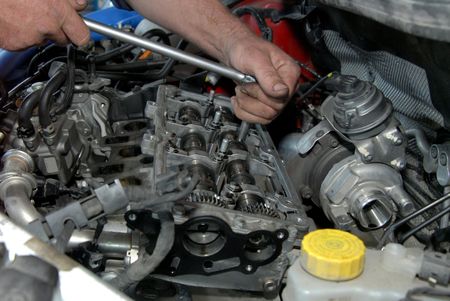 Man Repairing Transmission — East Longmeadow, MA — Hi-Tech Transmission Inc Man Repairing Transmission — East Longmeadow, MA — Hi-Tech Transmission Inc