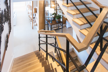 A wooden staircase with a metal railing in a house