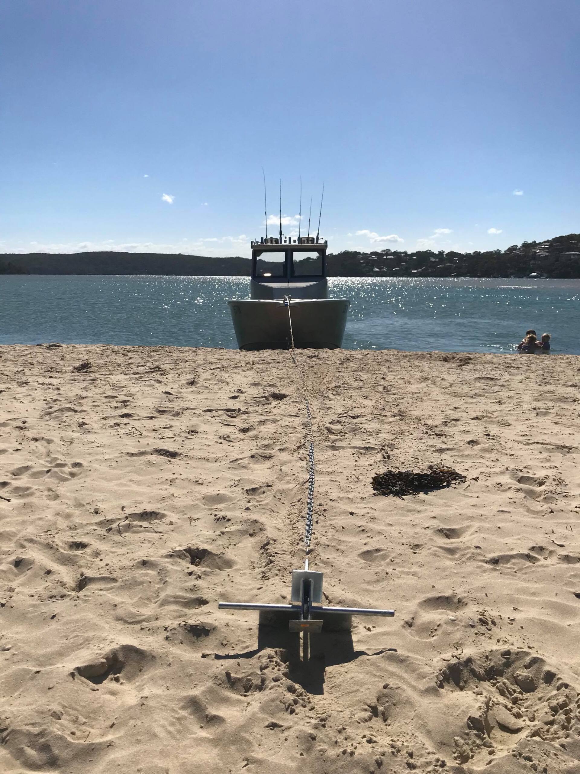 boat docked on sand beach