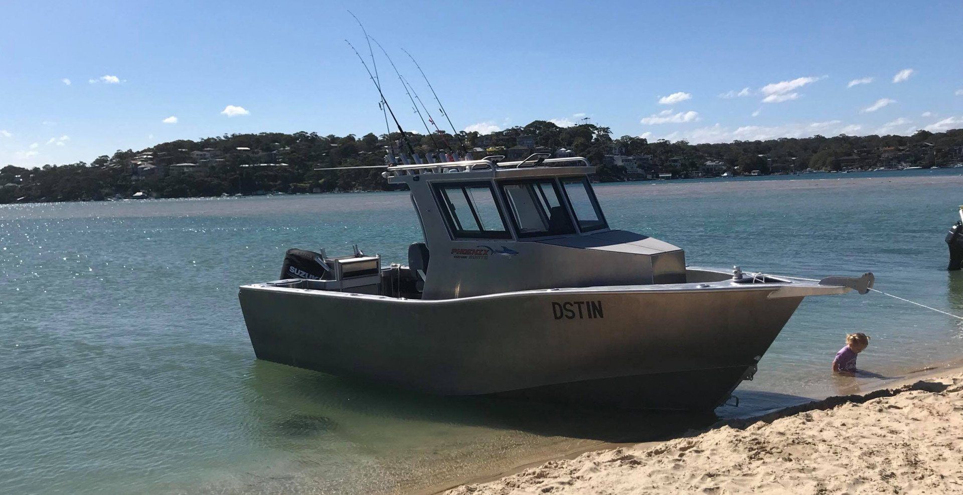 starboard and bow shots of a boat docked on sand beach