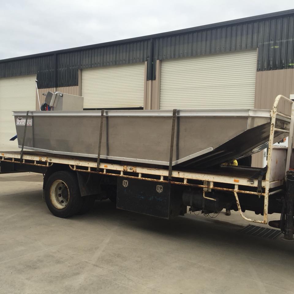 boat being hauled by a truck