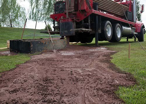 truck on road with well drilling equipment in Benedict, NE
