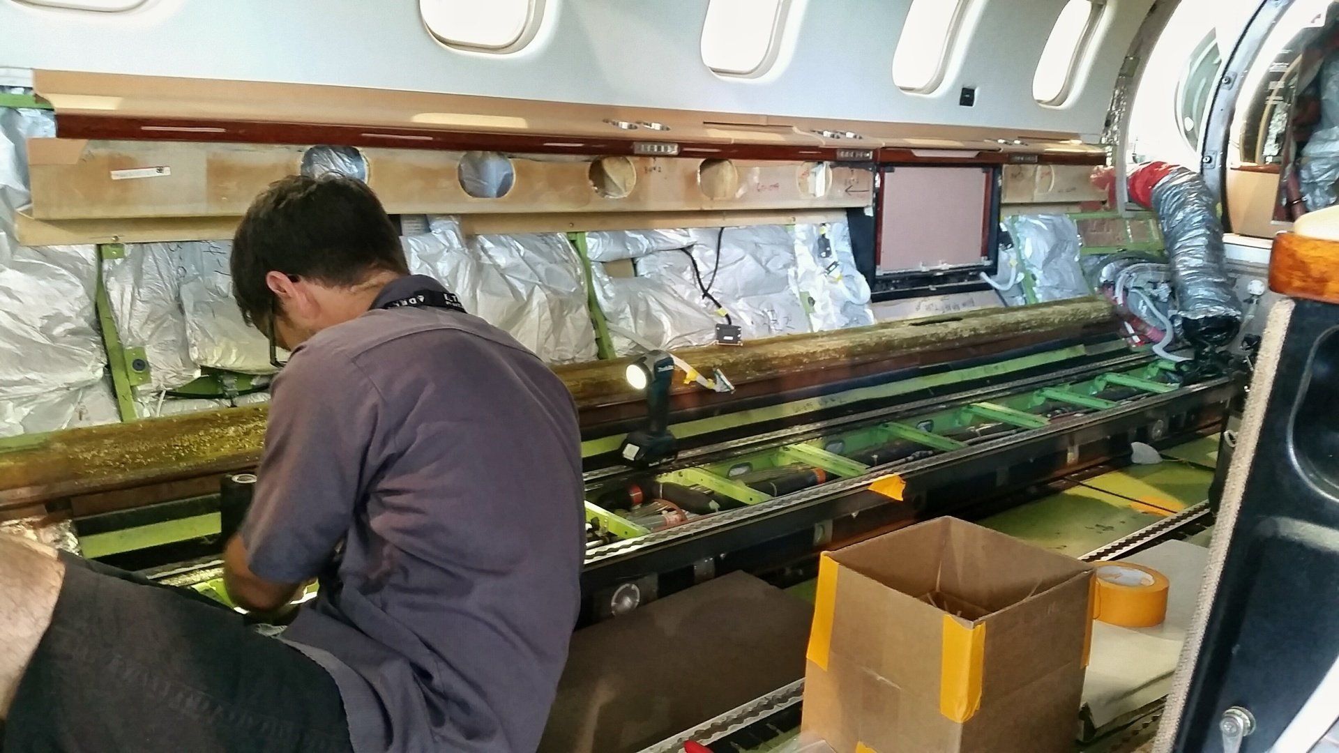 A man is working on the inside of an airplane