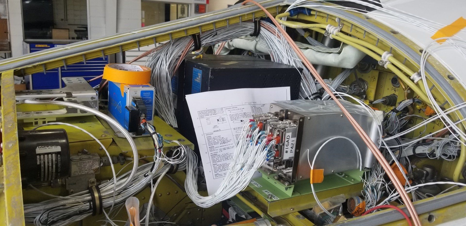 A close up of a machine with a lot of wires coming out of it.