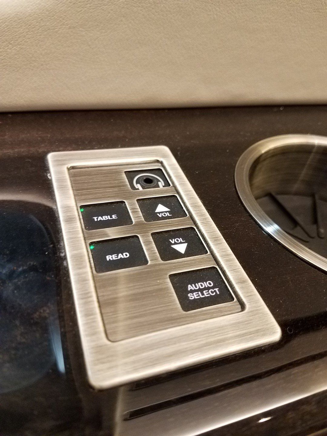 A remote control is sitting on a counter next to a sink.