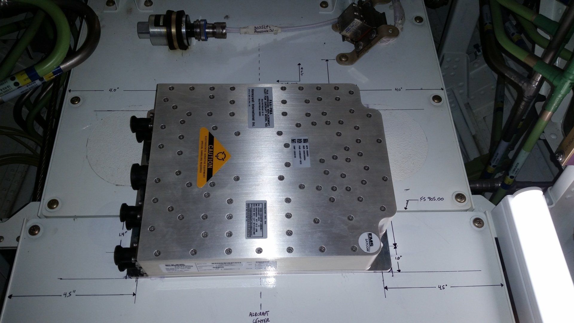 A metal box with a yellow warning sign on it
