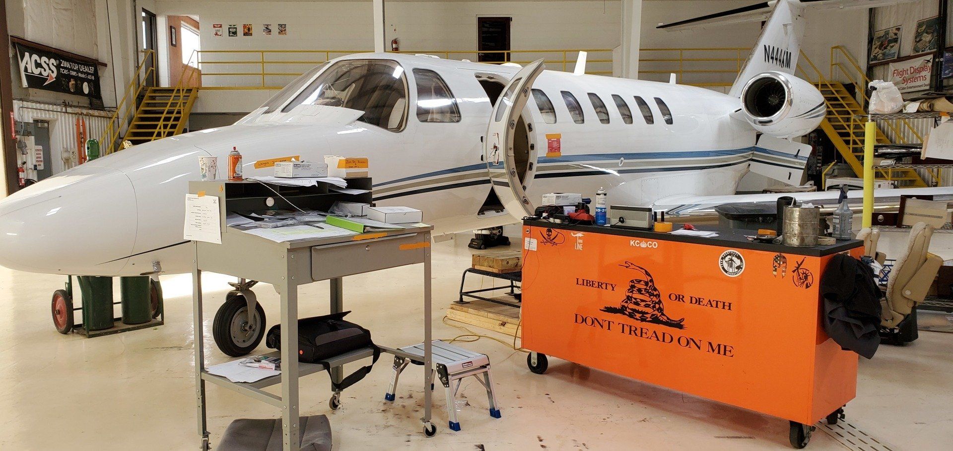 A small airplane is being worked on in a hangar