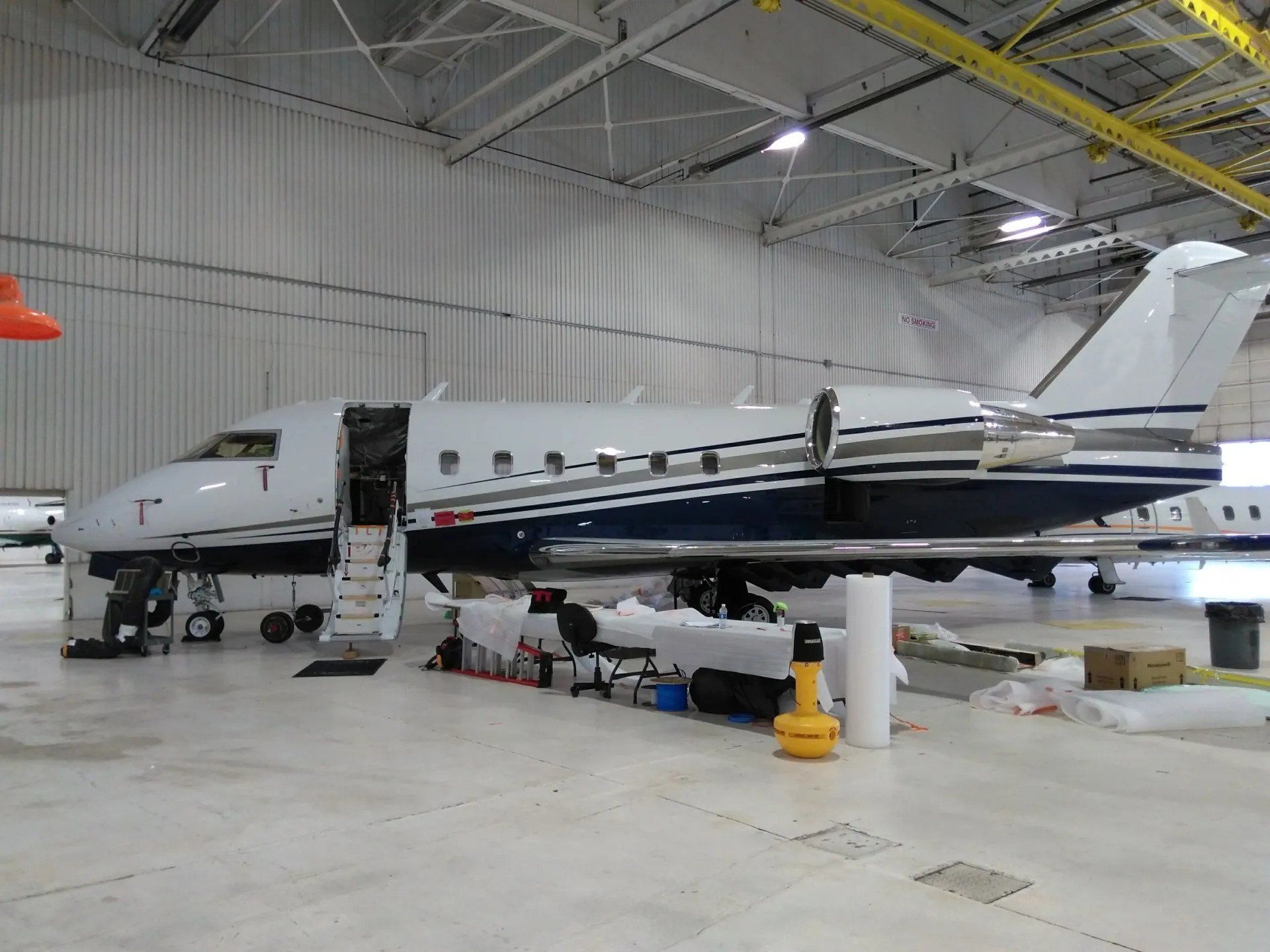 An airplane is parked in a hangar with the number 1 on the side