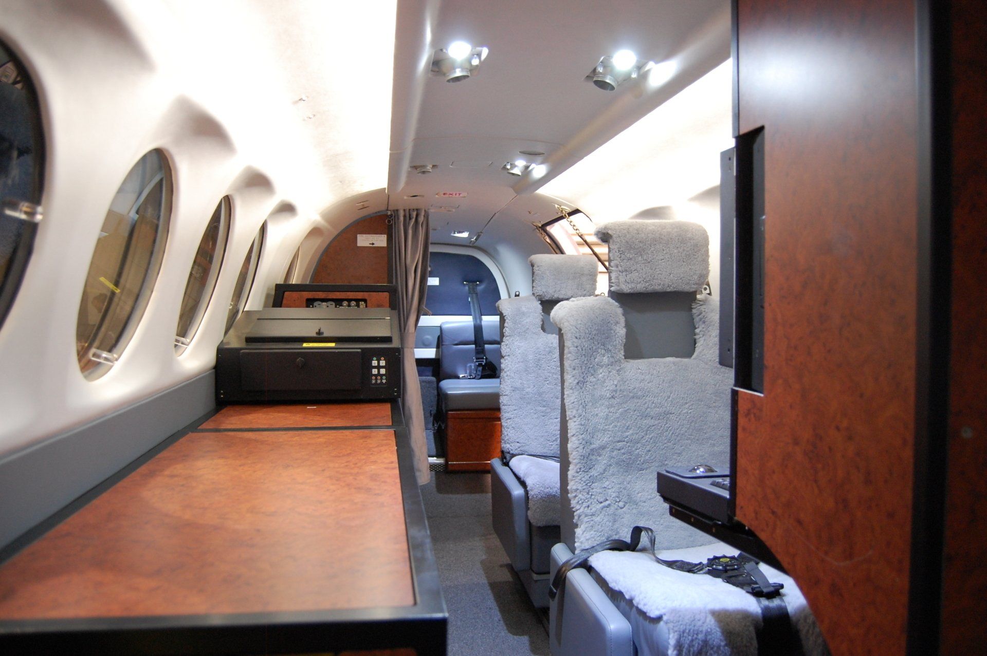 The inside of an airplane with a table and chairs