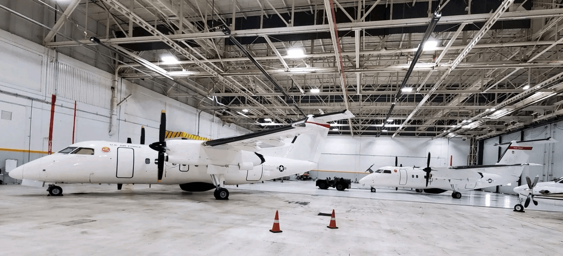 A large airplane is parked in a large hangar.