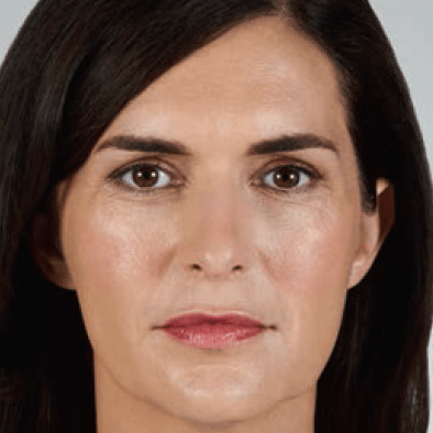 Woman with brown eyes and hair; visible wrinkles around eyes.