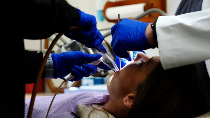 Get root canals at our family dental office in Metairie LA 70002 Working on dental patient | root canal treatment family dentist Metairie LA 70002