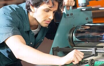 Man working on printing press — Design in Allentown, PA