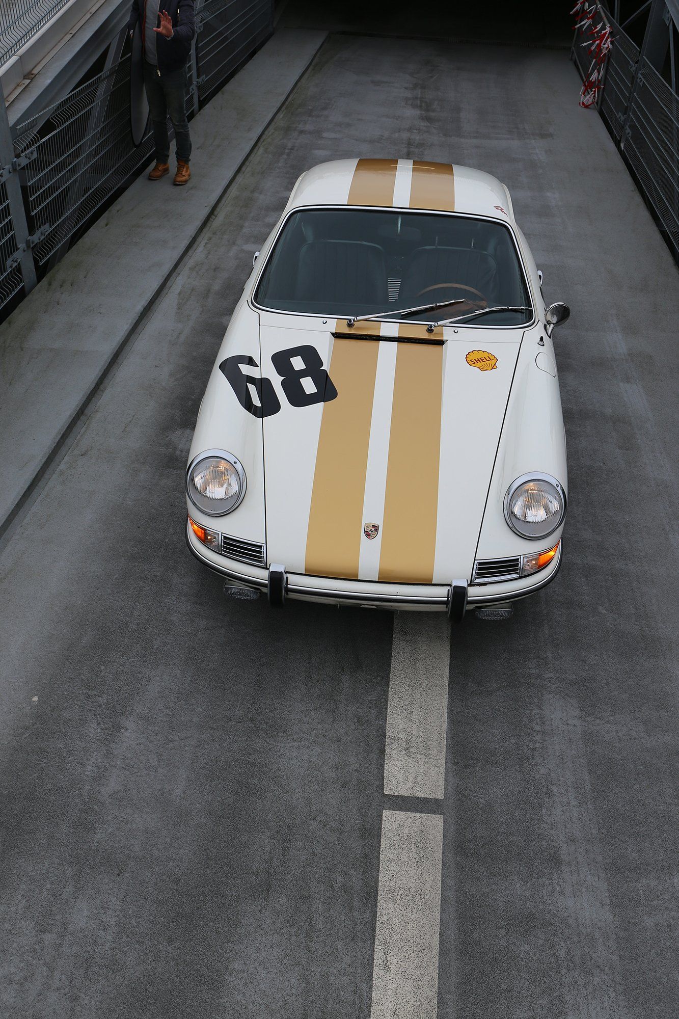 A white and gold race car with the number 68 on it