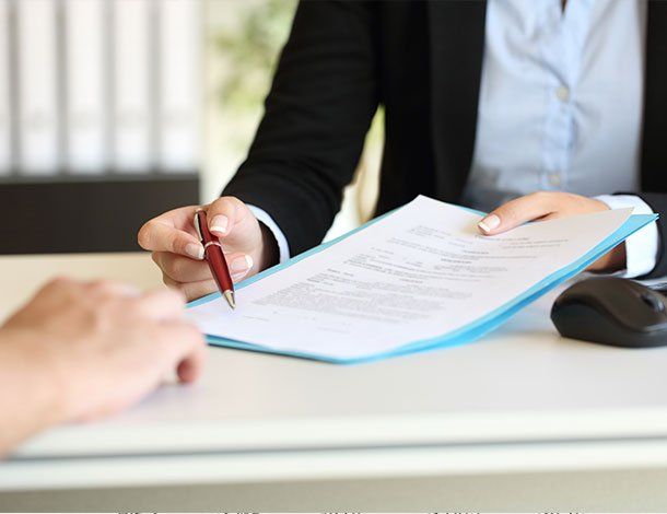 Attorney Holding Papers To Be Signed — Springfield, MO — Dunn Law Firm LLC Attorney Holding Papers To Be Signed — Springfield, MO — Dunn Law Firm LLC