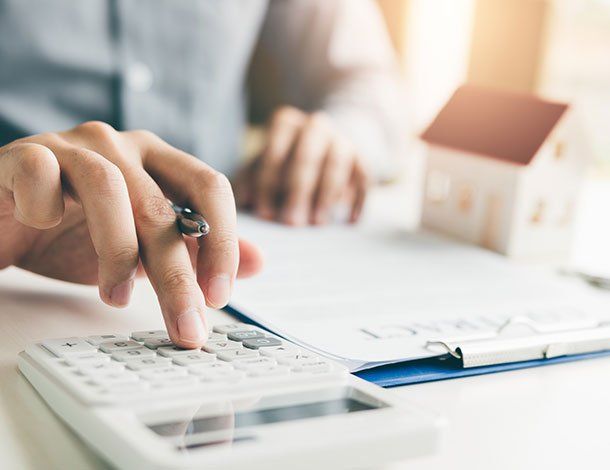 Man Using Calculator — Springfield, MO — Dunn Law Firm LLC Man Using Calculator — Springfield, MO — Dunn Law Firm LLC