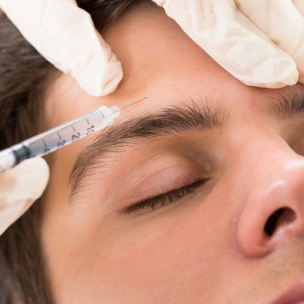 Man Getting an Injection — Metairie, LA — Dr. Carter D. Paddock Man Getting an Injection — Metairie, LA — Dr. Carter D. Paddock
