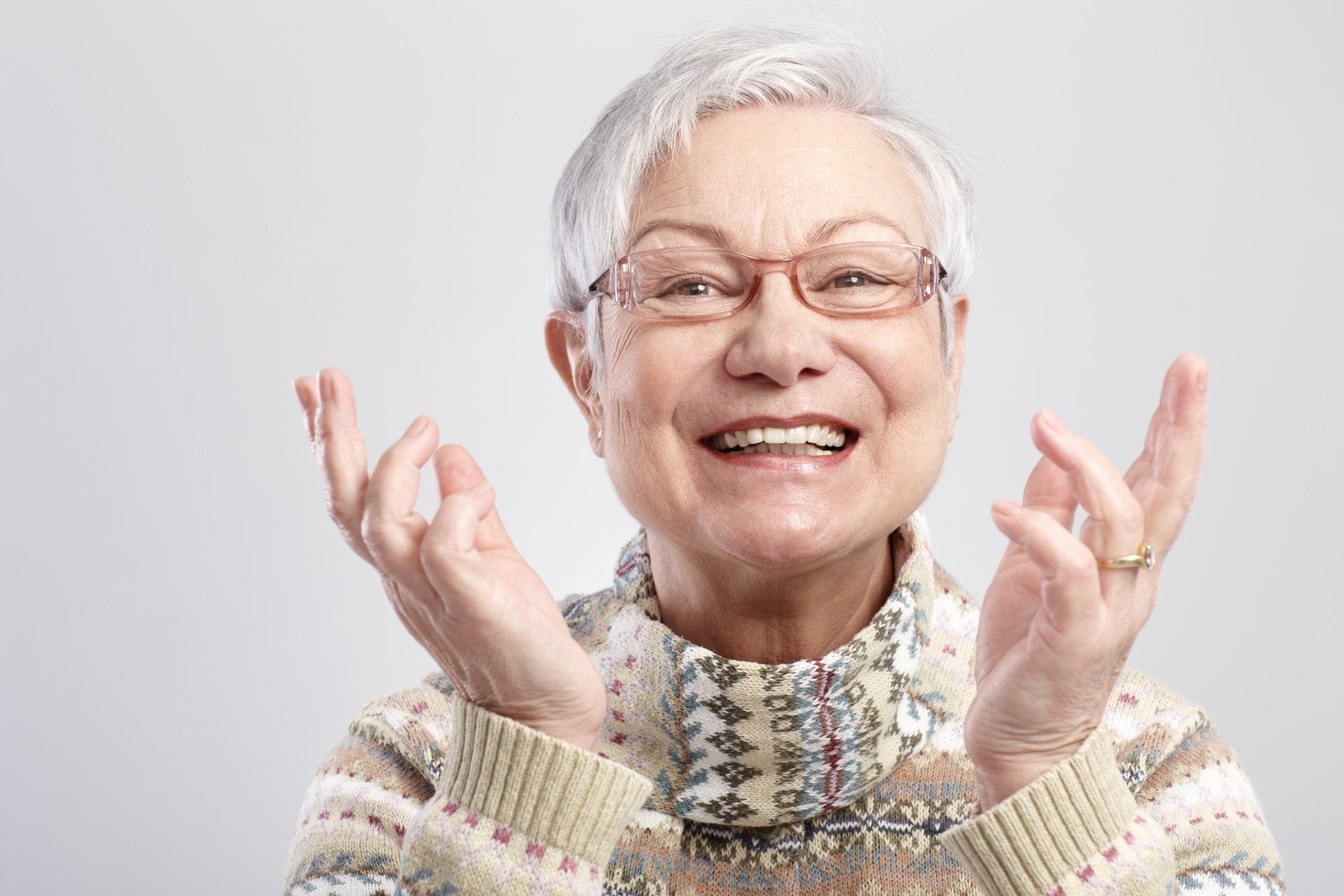 more mature lady smiling with a new set of crowns and bridges - Cosmetic Dentistry Christchurch