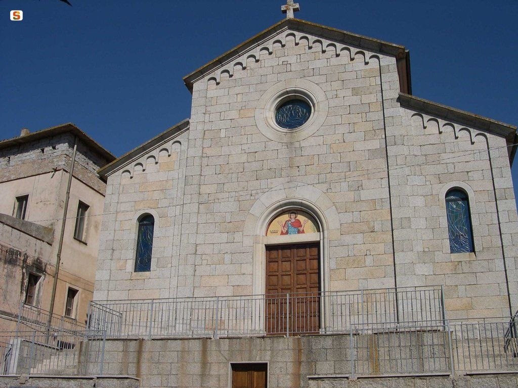 Facciata di una chiesa in pietra in stile romanico con ingresso centrale ad arco, rosone e croce sul tetto a due falde.