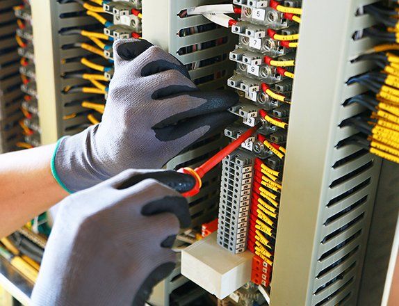 Electrician Fixing Electrical Terminal in Junction Box — Clairsville, OH — Bryan Electric Inc.