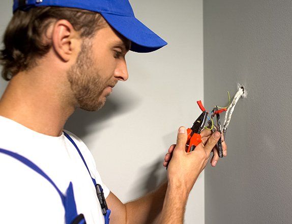 Electrician Stripping Wires — Clairsville, OH — Bryan Electric Inc.