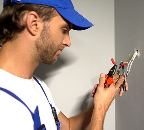 Electrician Stripping Wires — Clairsville, OH — Bryan Electric Inc.