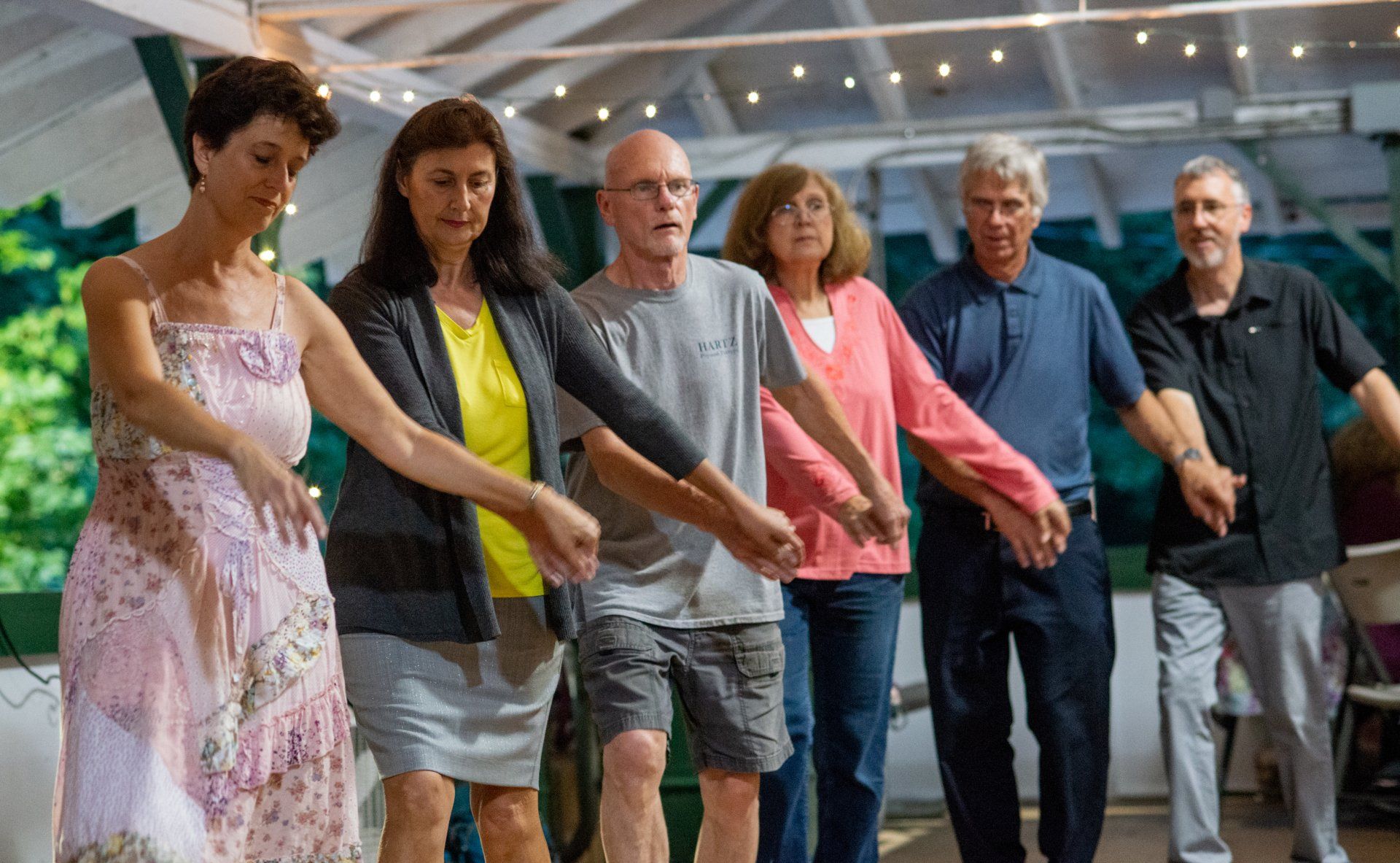 A group of people are holding hands in a circle.
