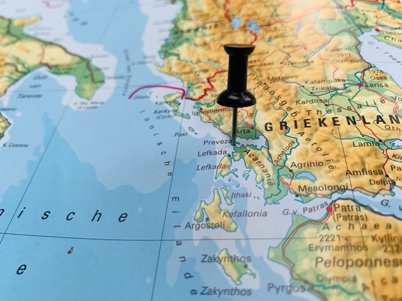 Pushpin marking a map near Greece and the eastern Mediterranean.