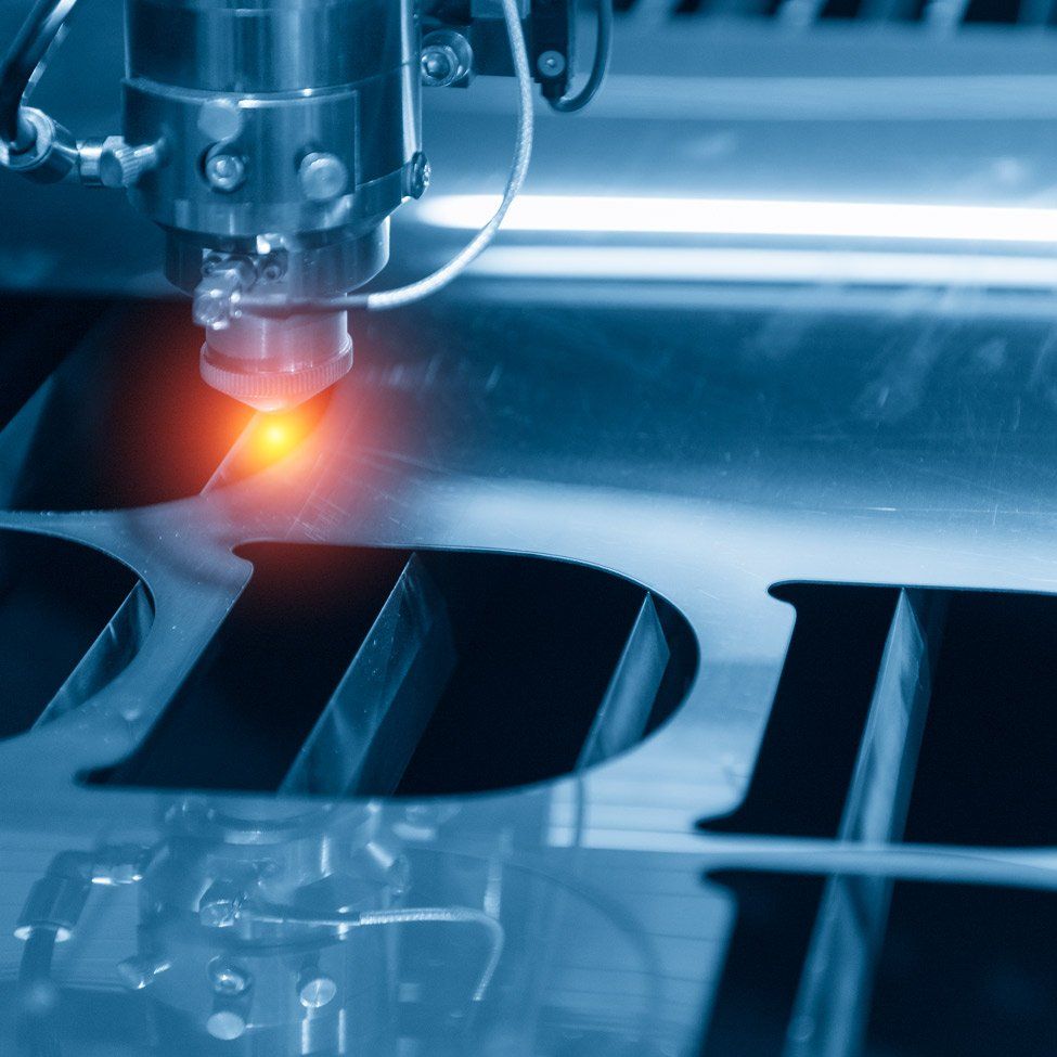 A machine is cutting a piece of metal with a laser.