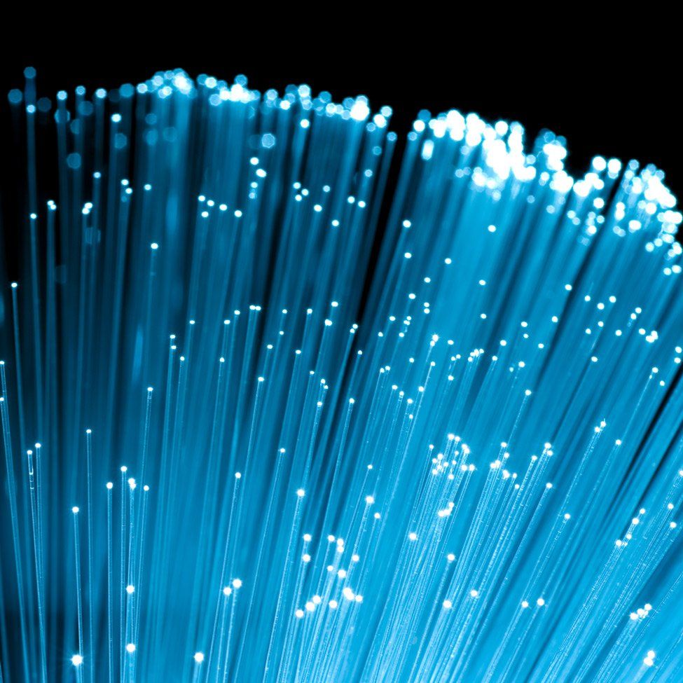 A bunch of blue fiber optics against a black background