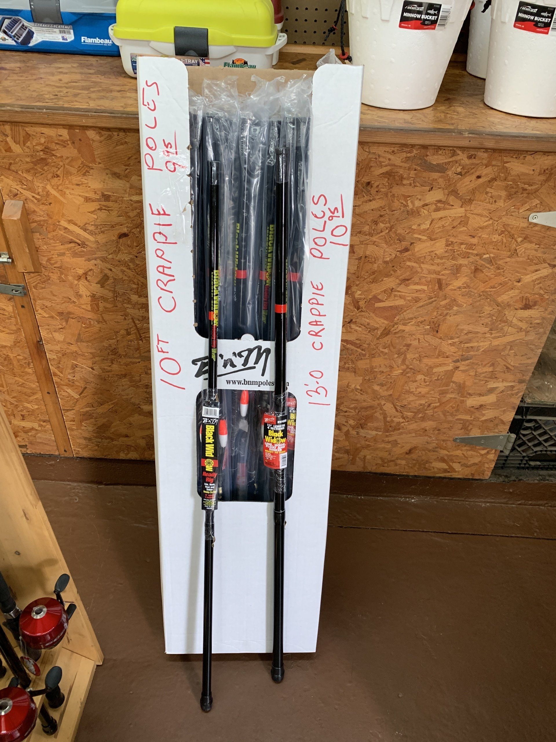 Fishing poles in a white box at a store. Text on box says 