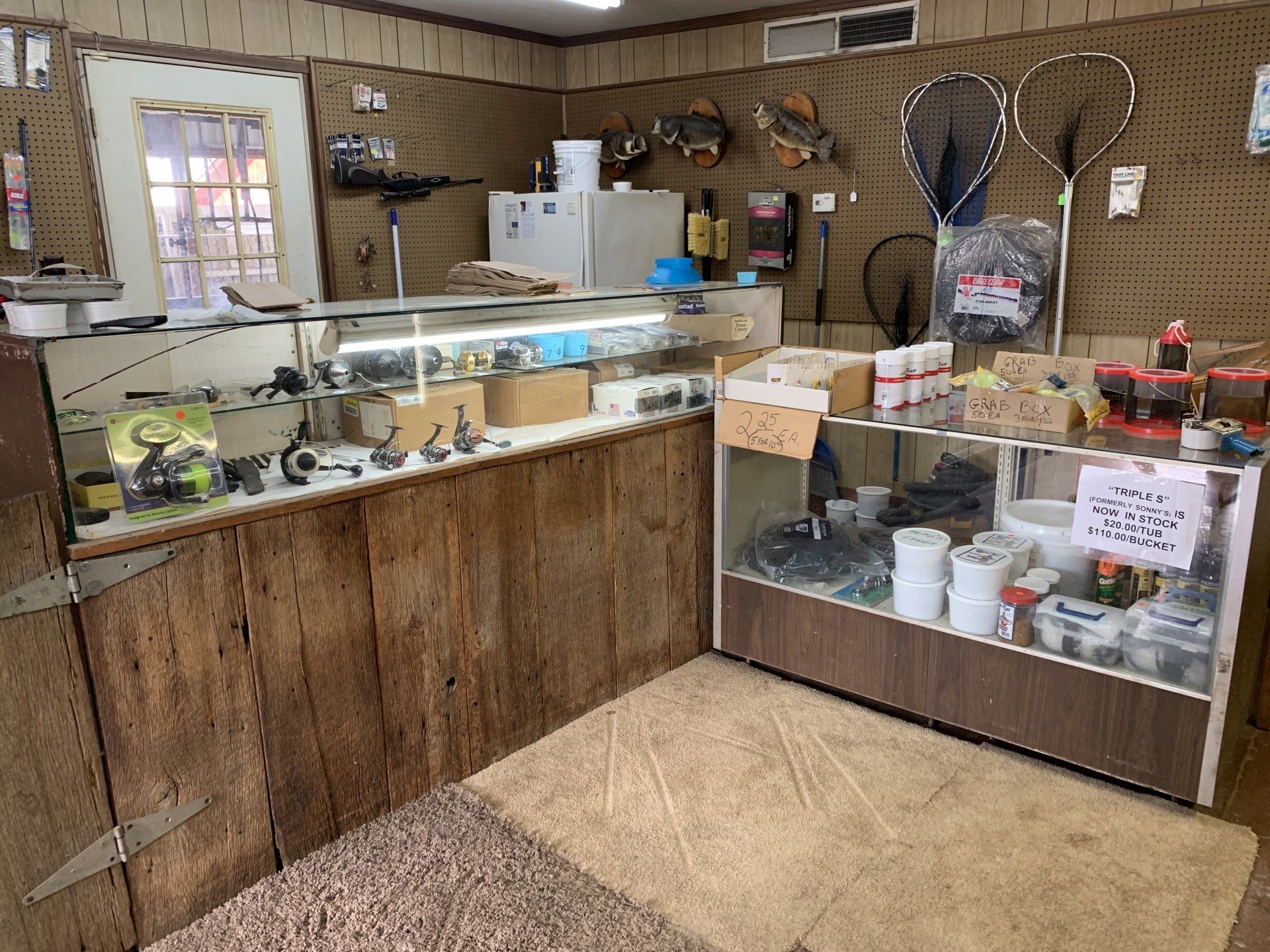 Inside a small fishing supply store, showcasing fishing gear and tackle.