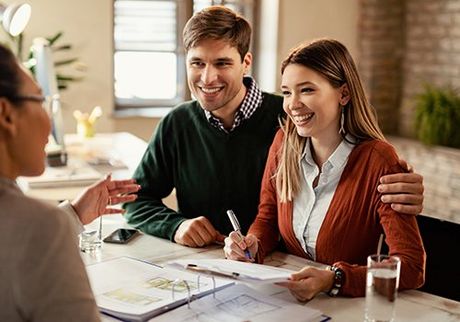 Happy Couple Talking to Insurance Agent — Greenwood, SC — Mabry Sanders Insurance Agency Happy Couple Talking to Insurance Agent — Greenwood, SC — Mabry Sanders Insurance Agency