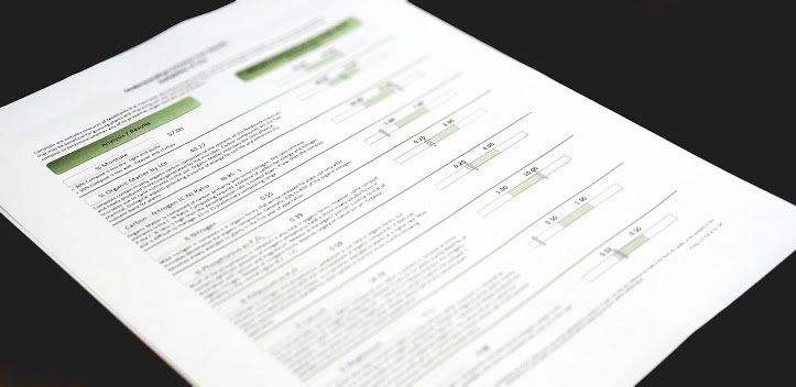 A piece of paper with a green line on it is laying on a table.