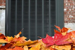 leaves piled around heat pump