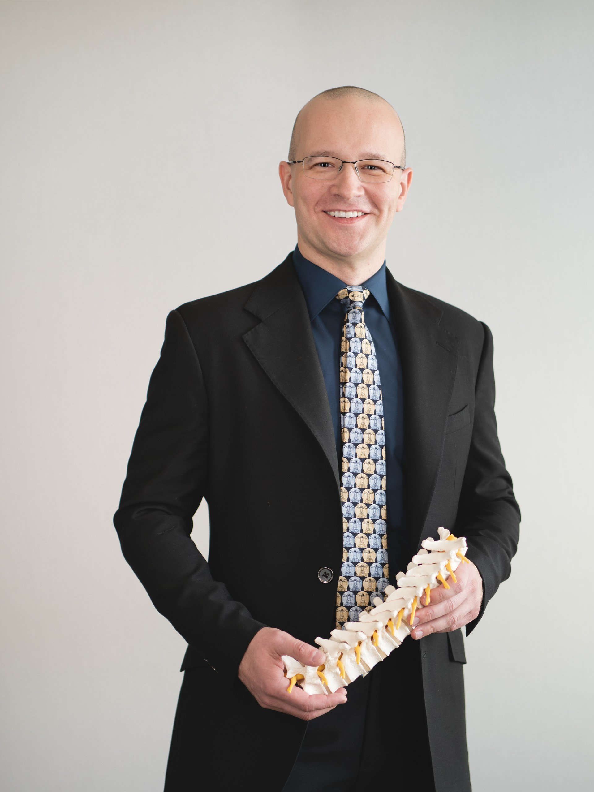Vladimir Sinkov md holding spine sculpture