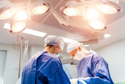 two-doctors-performing-spine-surgery