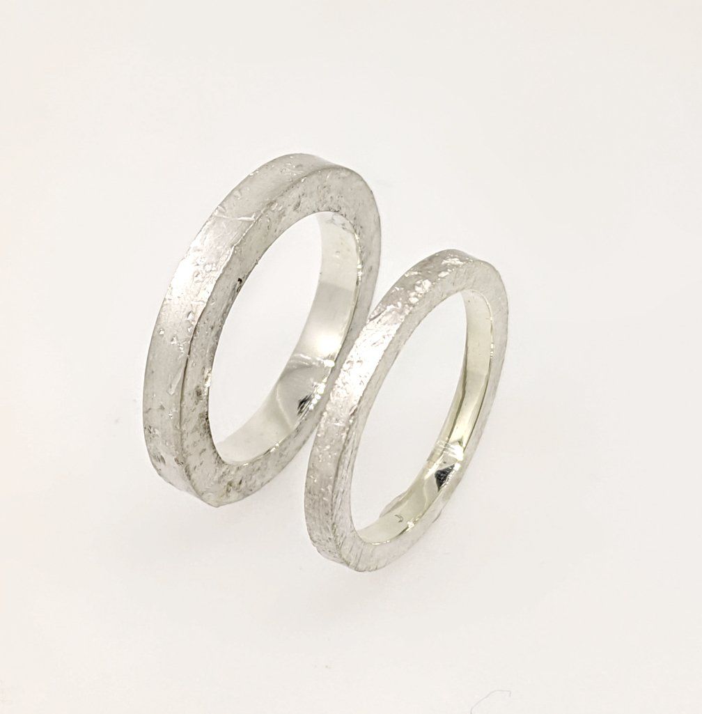 Reflections in Stone: Sculptural rings with concrete texture.